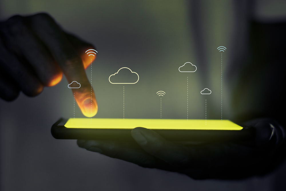 Ein Mann, der ein Tablet mit einem holografischen Bild einer Cloud benutzt, repräsentiert die Expertise und Innovation von Skywize bei der Bereitstellung fortschrittlicher Lösungen der Cloud Technologie